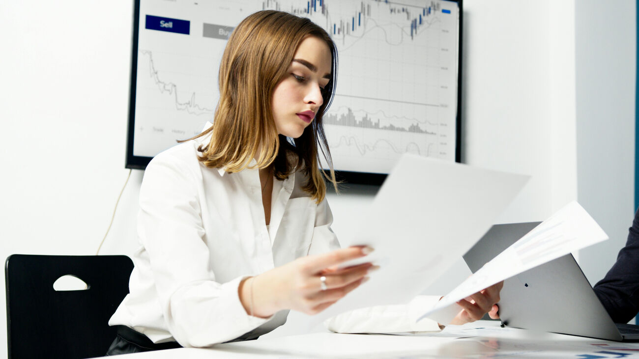 Financial services professional analyzing charts