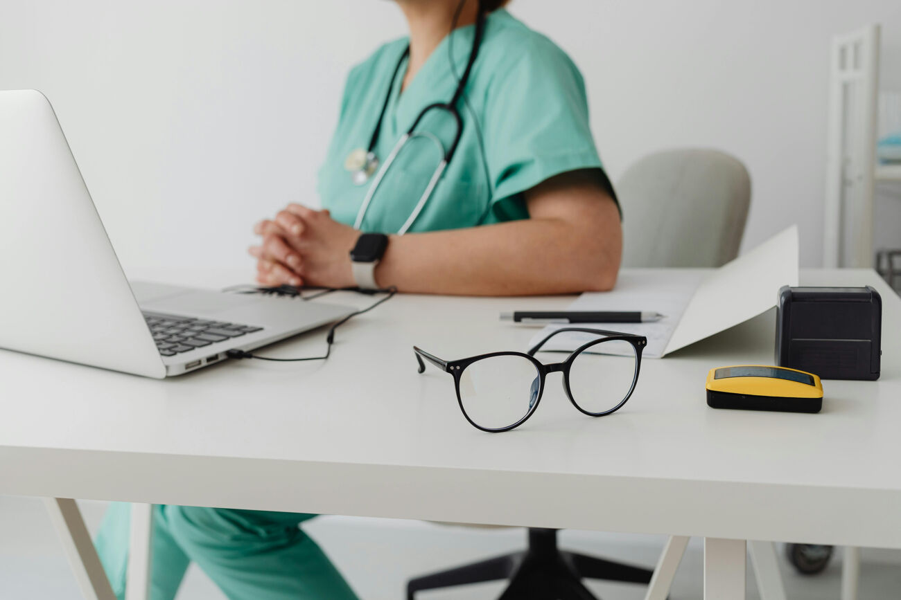 Healthcare professional with laptop and stethoscope