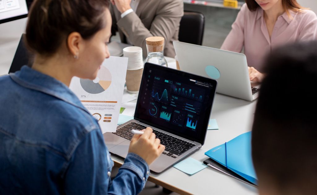 Data visualisation on a laptop, showing bar and line charts